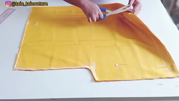 Cut the fabric, remembering to only notch (don't cut completely) the initial 5.5-inch neckline marking.