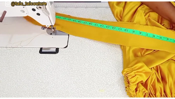 Create and attach the belt. The dimensions are 30 inches by 4 inches. Sew the belt, leaving an opening for turning it right side out. Press, then stitch the opening closed. Stitch or hand-sew the belt to the top, ensuring even distribution of the elastic.