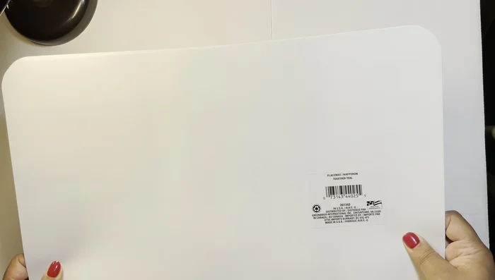 Prepare the placemats: Lay two placemats together, creating a slight lip for later folding.