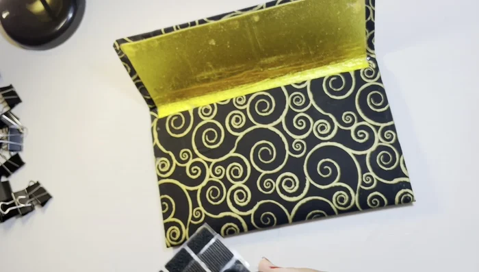 Add Velcro Closure: Attach velcro pieces to the clutch to create a secure closure.
