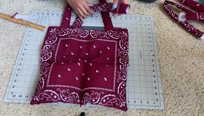 Sew across the top of the straps, attaching them to the bag.