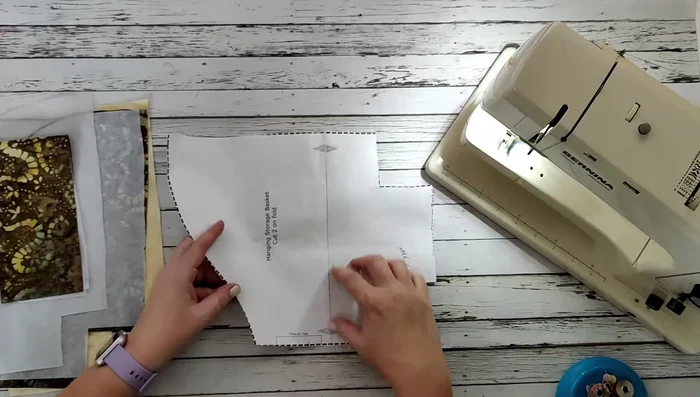 Cut out the strap (14" x 3.5"). Fuse interfacing to the wrong side of both the main fabric pieces and the strap.