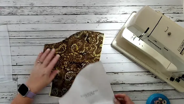 Cut out the strap (14" x 3.5"). Fuse interfacing to the wrong side of both the main fabric pieces and the strap.