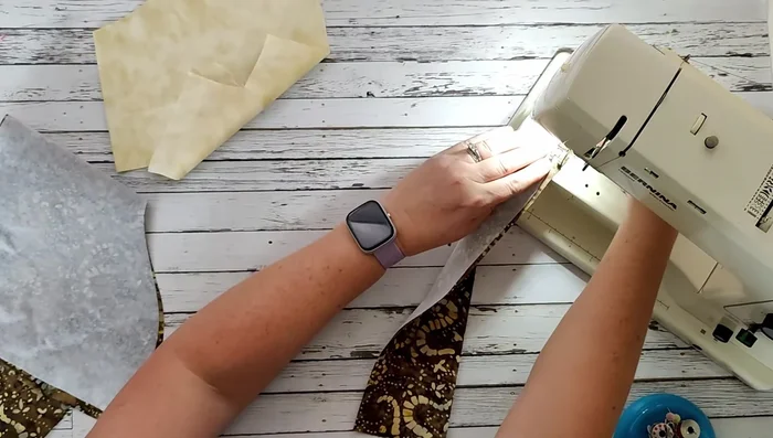 Fold the strap in half (right sides together), and stitch along the long edge (approximately 3/8" seam allowance). Turn right side out using a turning tool.