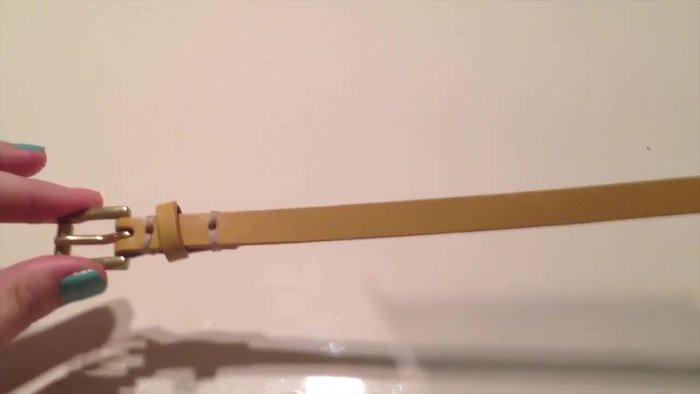 Measure a couple of inches from the mark and cut the belt.