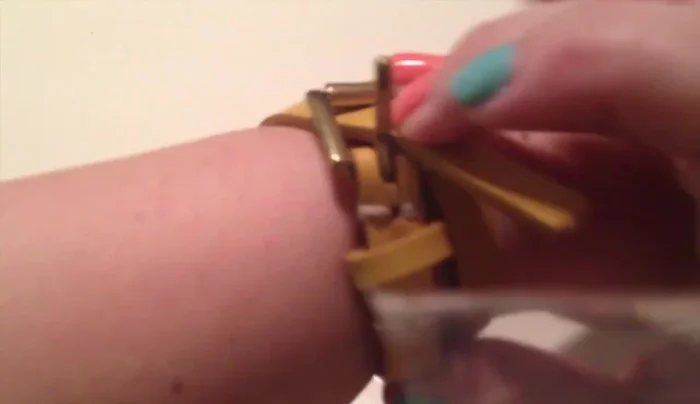 Hammer a nail into the belt to create a new hole (using a screw afterwards can make it easier).