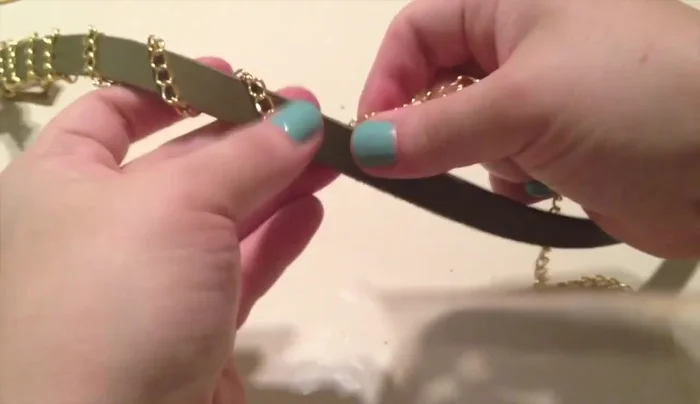 Wrap the chain around twice, cut off excess, and secure with another jump ring. Consider adding string for extra security.