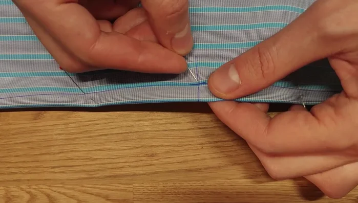 Machine stitch the dart, avoiding backstitching at the corners. Instead, stitch, turn the needle at the end, and stitch again to prevent puckering.