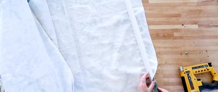 Paint or leave raw the wooden piece. Staple fabric to wood.