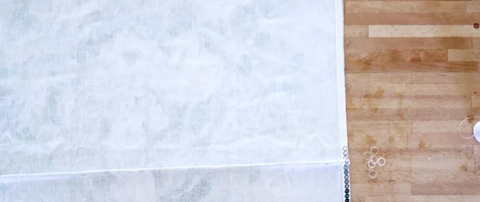 Hand-sew plastic shade rings onto the fabric, 3 inches from each edge and in the middle of each casing.