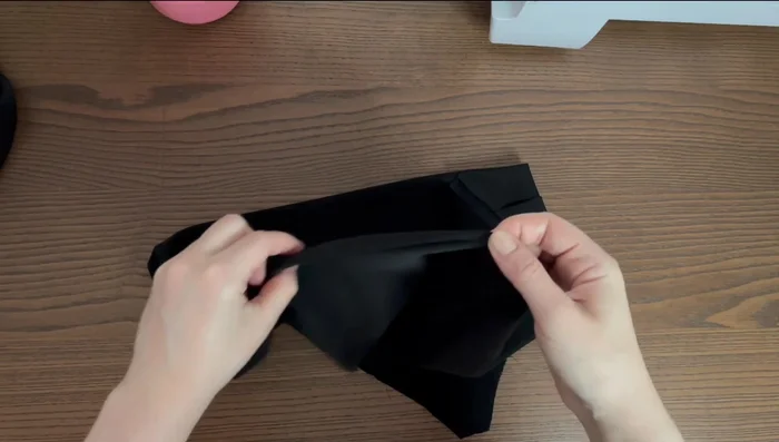 Roll the hem up again to the wrong side, press, and baste. Stitch another straight line directly on top of the first one.