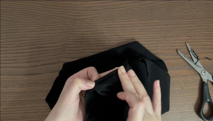 Roll the hem up again to the wrong side, press, and baste. Stitch another straight line directly on top of the first one.