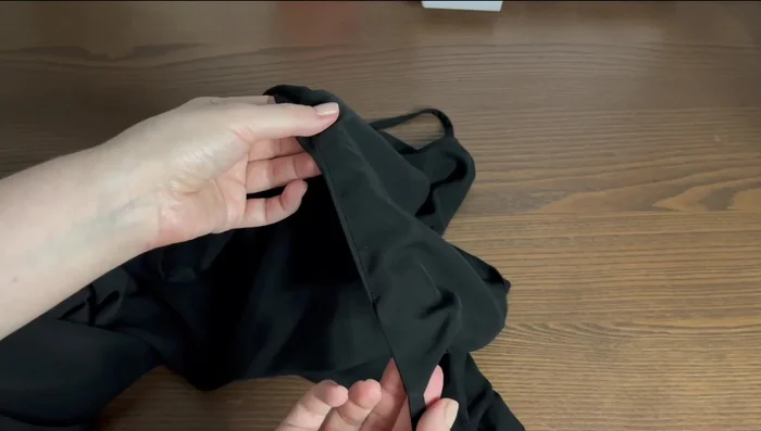 Stitch the seam allowance to the facing. Place the line of stitch one to two millimeters away from the original seam on the face and right side. Press the upper edge slightly, rolling the seam towards the facing. Hand stitch the facings and the dress side seams together.