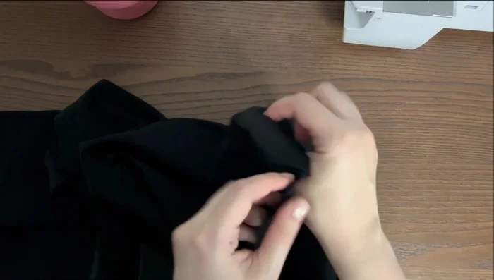 With the garment's right sides together, stitch using a six-millimeter seam allowance. Cut the raw edge.