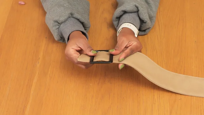 Reinforce the buckle attachment: Fold the raw edge of the belt twice and stitch it close to the folded edge to secure the buckle.