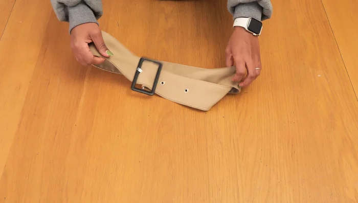 Attach belt loops: Attach the loops to the trench coat waistline.