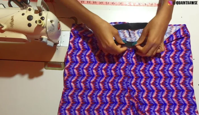 Pin the elastic to the garment, ensuring even distribution.