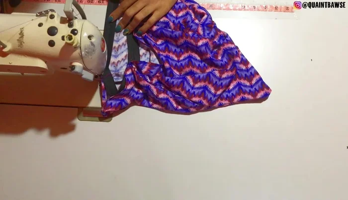 Fold the fabric down and stitch along the very edge again to secure the elastic.