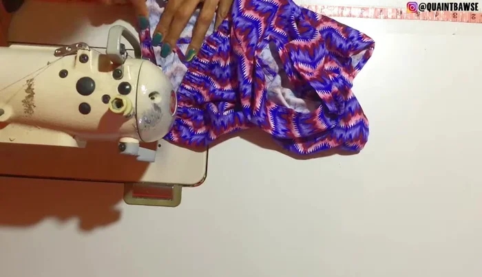 Fold the fabric down and stitch along the very edge again to secure the elastic.