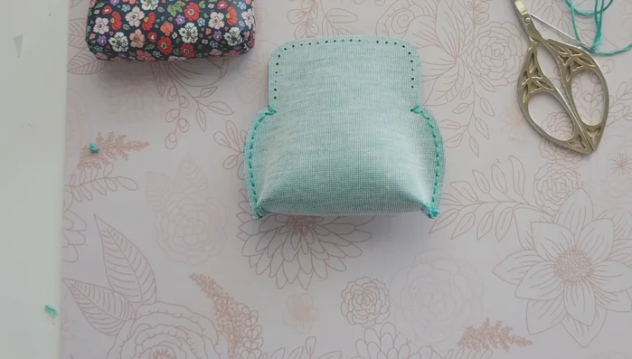 Turn the purse inside out carefully using a blunt object to help push out the corners.