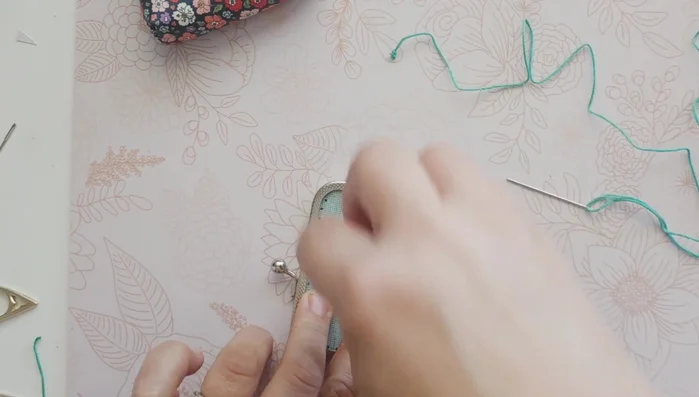 Tie off the embroidery floss, creating a knot and securing it with super glue.