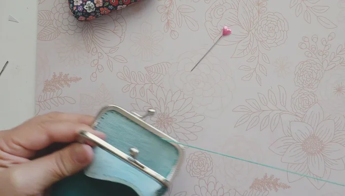 Tie off the embroidery floss, creating a knot and securing it with super glue.