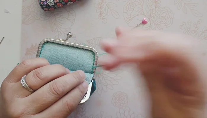 Tie off the embroidery floss, creating a knot and securing it with super glue.