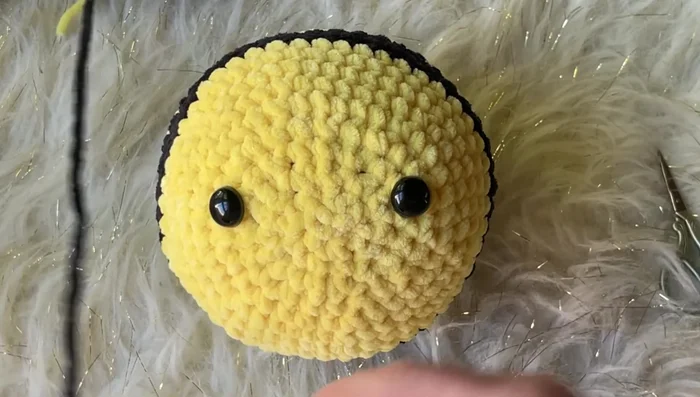 Embroider Smile: Use yarn to embroider a smile.