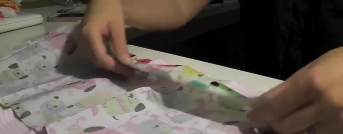 Pin the hem of the sewn hoop to the hem of the shirt.