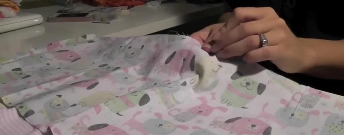 Pin the hem of the sewn hoop to the hem of the shirt.