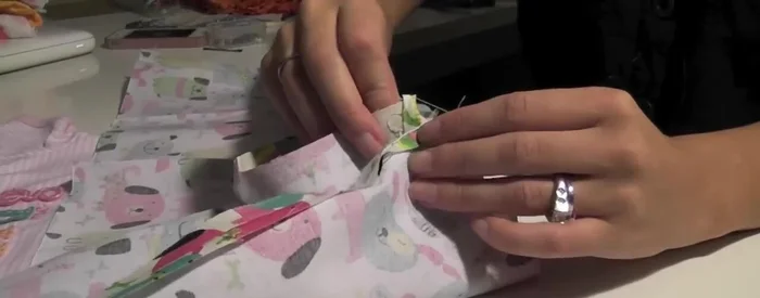 Pin the hem of the sewn hoop to the hem of the shirt.