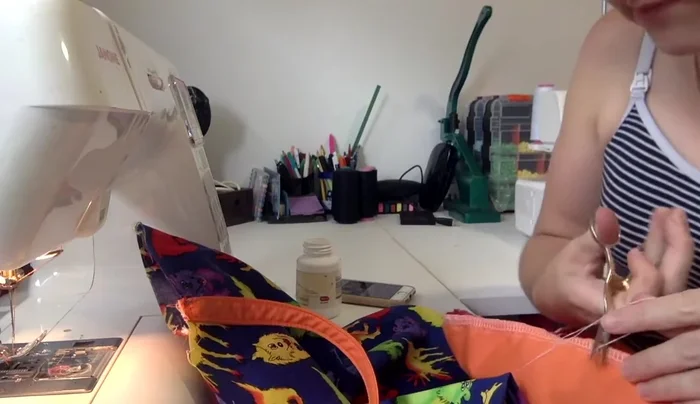 Attach lining to main fabric: Place the main fabric inside the lining (right sides together), aligning side seams and pinning around the top edge, tucking handles inside.