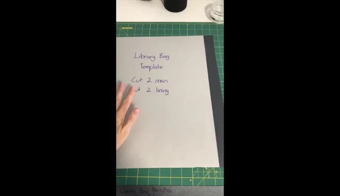 Prepare fabric pieces: Cut out two main fabric pieces, two lining pieces, and two handle pieces. Iron interfacing onto handle pieces and pin pairs together.