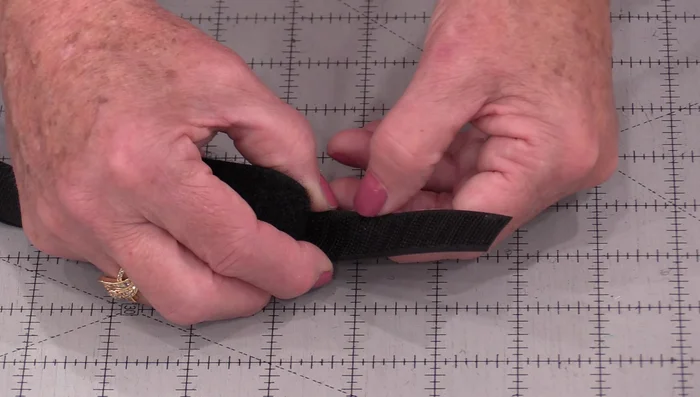 Adjust Needle Position: Adjust your needle position so it stitches right along the edge of the Velcro, inside the channels you created.