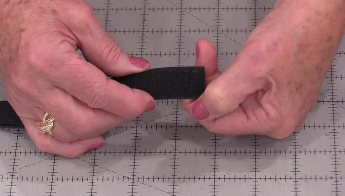 Adjust Needle Position: Adjust your needle position so it stitches right along the edge of the Velcro, inside the channels you created.