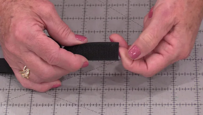 Adjust Needle Position: Adjust your needle position so it stitches right along the edge of the Velcro, inside the channels you created.