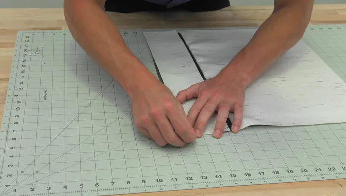 Reduce bulk at the corners by cutting a small wedge from each corner (about a half-inch from the corner, extending diagonally 4.5 inches across the panel).