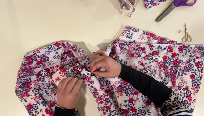 Finish raw edge of outer facing edge: Backstitch to hold down the pleat.