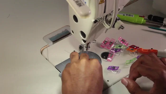 Assemble the exterior of the diaper bag, attaching all previously made components.