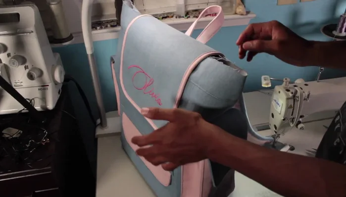 Assemble the exterior of the diaper bag, attaching all previously made components.