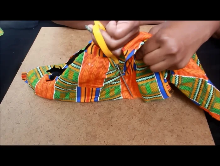 Glue down the excess fabric at the top of the shoe and around the edges.