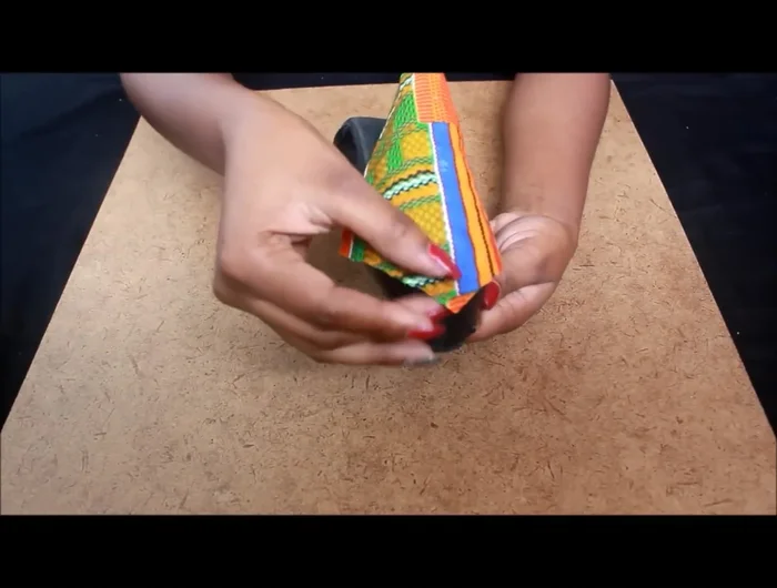 Cut the top portion of the triangle away from the heel using an exacto blade.