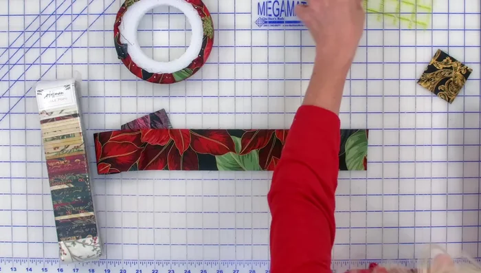 Cut and Press Fabric Squares: Cut 2.5-inch squares from your Jingle Pop strips. Fold each square in half, press, then fold the flaps in to create a point, and press again.