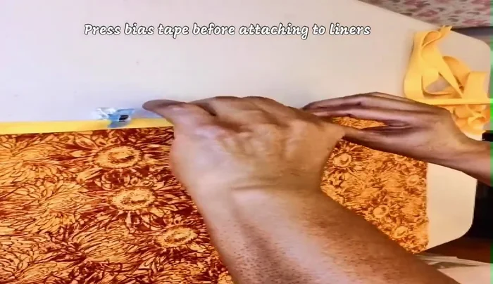 When approaching the other end, stitch a bit before removing from machine. Cut bias tape 1/4 inch past the end.