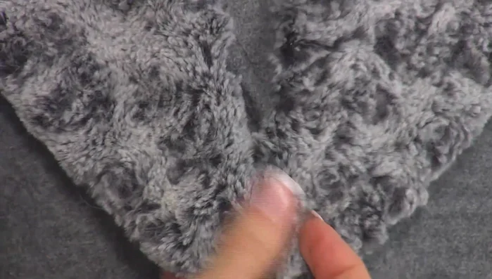 Attach the collar to the jacket using hooks or other fasteners.