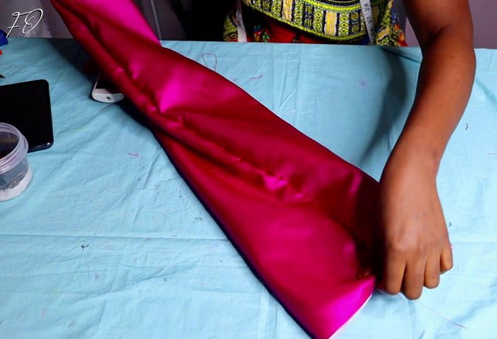 Turn inside out and position stitch line: Turn the fabric inside out and move the stitch line to the center.