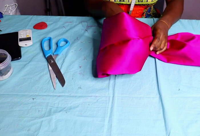 Press and sew center: Press the center of the folded fabric together and sew it securely for a clean look.