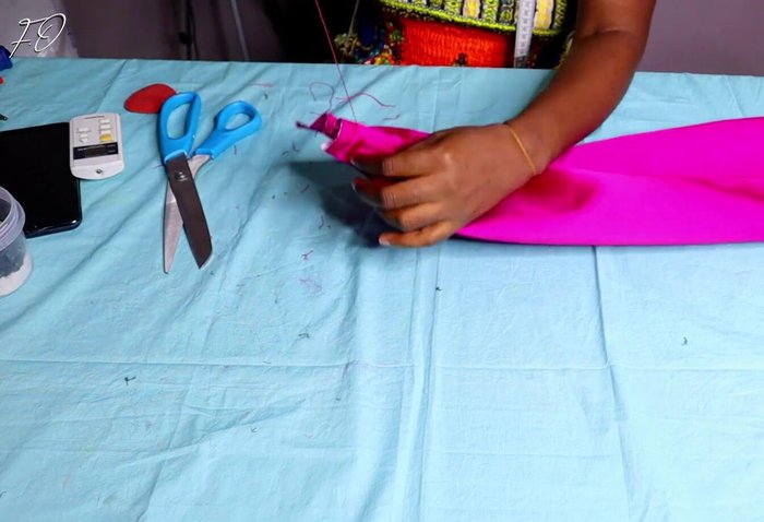 Press and sew center: Press the center of the folded fabric together and sew it securely for a clean look.