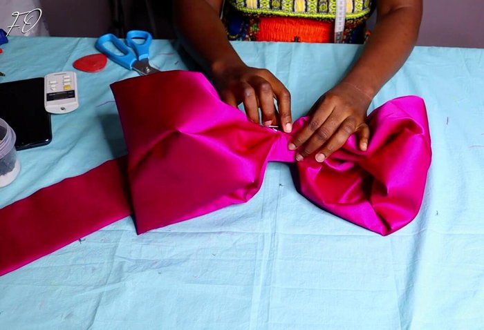 Press and sew center: Press the center of the folded fabric together and sew it securely for a clean look.