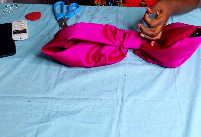 Sew and secure the bow: Secure the fabric covering the bow’s center by sewing it down to the bow.